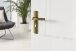 AXA deurkrukset Curve klik blindschild met cilindergat brons